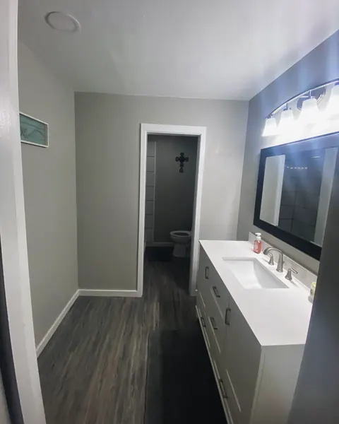 Finished bathroom with vanity, from Jennings Plumbing’s own photographs.