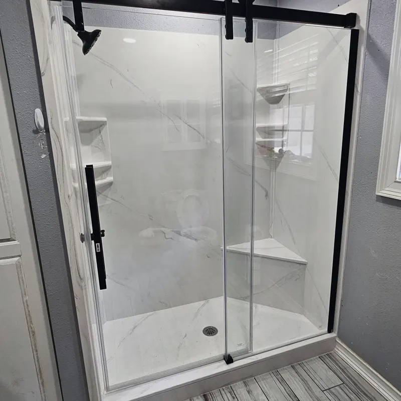 Finished shower with glass door, from Eschberger Plumbing Company LLC’s own website.