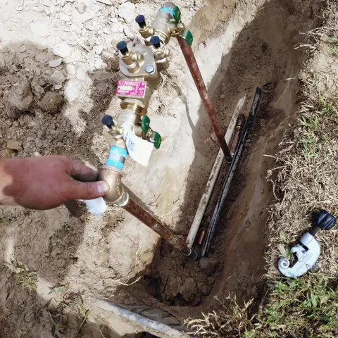 Water line repair in excavation, from Eschberger Plumbing Company LLC’s own photographs.