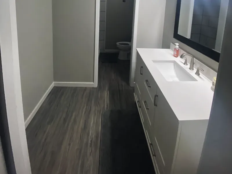 Finished bathroom with vanity, from Jennings Plumbing’s own website.
