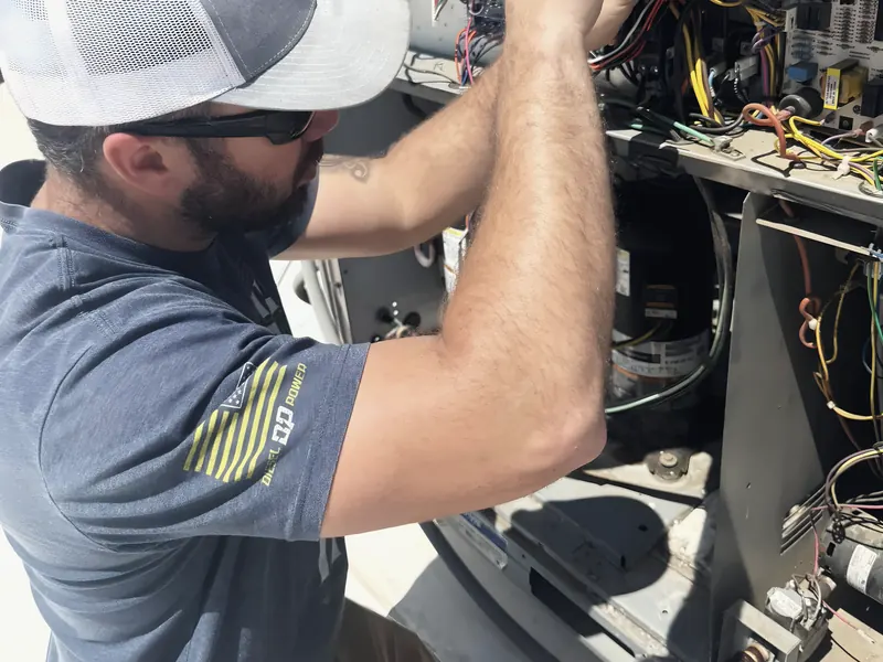 Technician servicing HVAC unit, from L&L Mechanical Services’s own website.