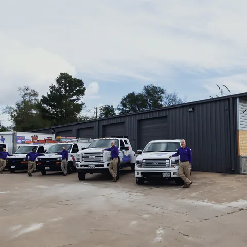Fleet of branded trucks with crew at the Royal Plumbing shop, from Royal Plumbing and Construction LLC’s own photographs.