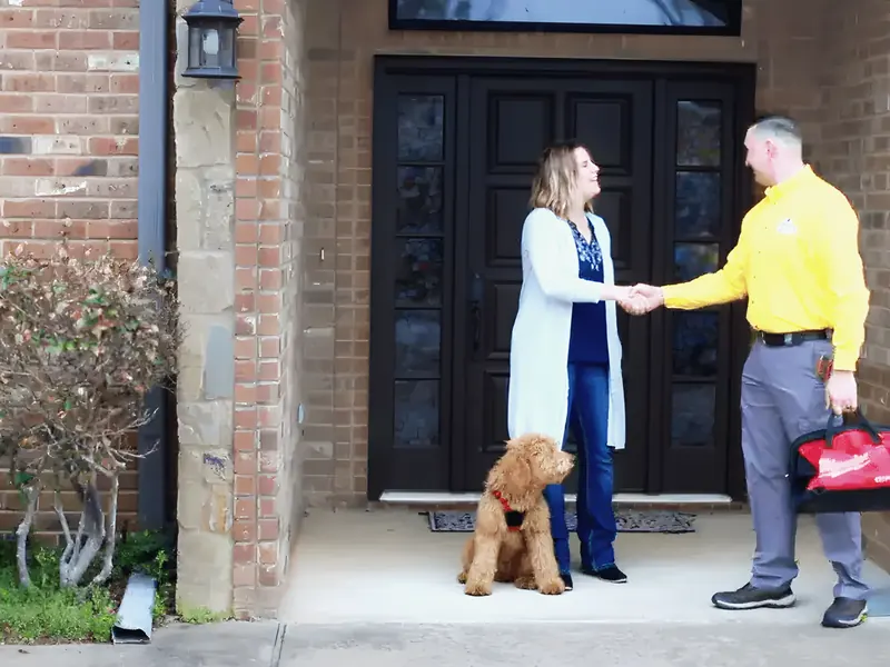 Uniformed technician greeting homeowner at the door, from Rub-A-Dub Plumbing’s own website.